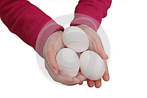 Child hands holding a three eggs
