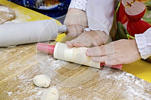 Child hands knead dough, cooks pizza, bake cookies, croissants for mother, father. Little kid daughter having cooking pastries or