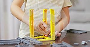 Child hands play with colorful plastic toy bricks and constructor game blocks.