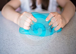 Child hands playing with colorful clay. Homemade plastiline.