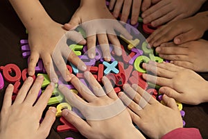 child hands playing with colorful numbers, counting concept