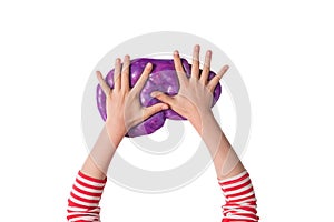 Child hands and purple shiny slime. Child girl plays with slime isolated on white. Home educational games concept. Top