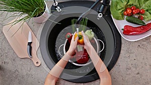 Child hands washing vegetables for a salad