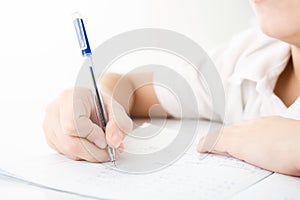 Child hands writing a homework