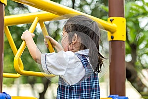 Child Hanging Bar at Playground