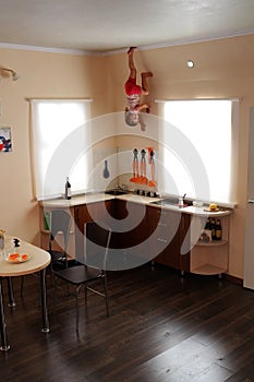 Child hanging up side down in kitchen