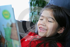 Child happily reading a book