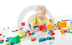 Child happy playing blocks over white