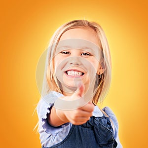 Child, happy portrait and thumbs up in studio for support, like emoji or yes for approval. Face of young girl kid on a