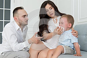 Child has fever and cold - baby is crying and family parents take care