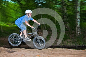 Child has fun jumping with thÃÂ© bike