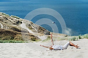 A child has fun in the sand dunes on the beach in Nida.Lithuania
