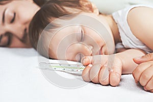 Child has a high temperature or fever, using a thermometer