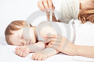 Child has a high temperature or fever, using a thermometer