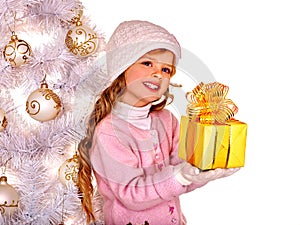 Child in hat and mittens holding gold gift box