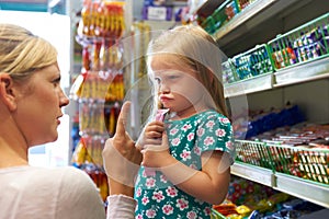 Child Having Arguement With Mother At Candy Counter photo