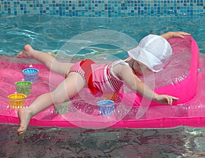 Child having fun an inflatable mattress