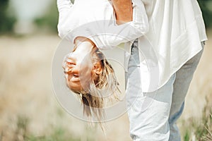 Child headfirst. Happy family playing in nature