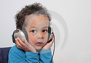 Child with headphones enjoying music stock photo