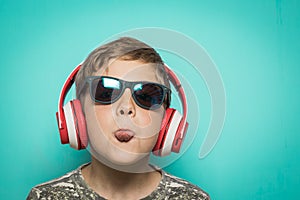 Child with headphones of music and funny expression