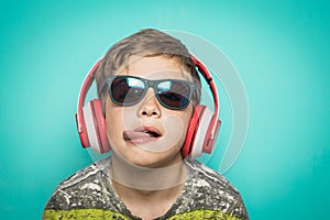 Child with headphones of music and funny expression