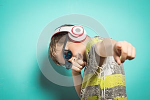 Child with headphones of music and funny expression