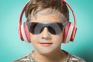 Child with headphones of music and funny expression