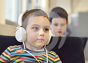 Child with headphones in school or library