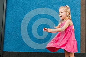 Child with hearing problem and cochlear implant dance in street, deaf kid began to hear. Hearing loss in childhood and