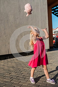 Child with hearing problem and cochlear implant dance in street, deaf kid began to hear. Hearing loss in childhood and