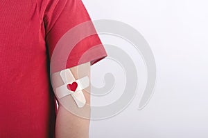 Child with a heart drawn on his arm. Blood donation concept