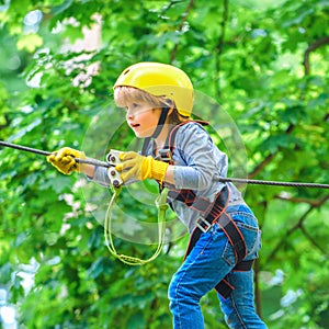 Child. Helmet and safety equipment. Hiking in the rope park girl in safety equipment. Toddler kindergarten. Early