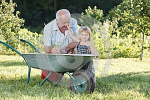 Child is helping her Grandfather