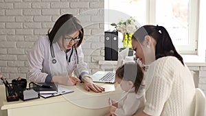 A child with her mother at a doctor`s appointment.