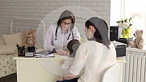 A child with her mother at a doctor`s appointment.