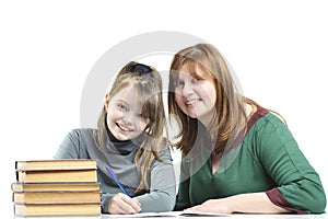 Child with her mother doing school lessons.