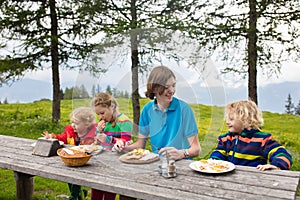 Child hiking in mountains. Picnic for kids.