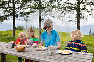 Child hiking in mountains. Picnic for kids