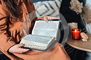 The child in his hands holds the Bible close-up