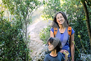 A child with his mother go hiking