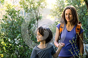 A child with his mother go hiking