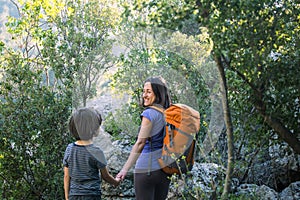 A child with his mother go hiking