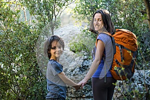 A child with his mother go hiking