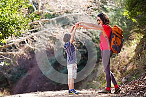 A child with his mother go hiking