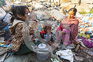 Child and his parents during lunch in break between working on dump.