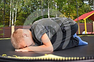 The boy is crying in the playground. Children`s resentment and problems