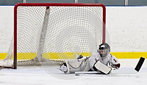 Child hockey goalie making a save