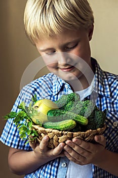 Child hold basket with green vegetables