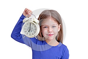 Child holding alarm with 7 o'clock on clock face