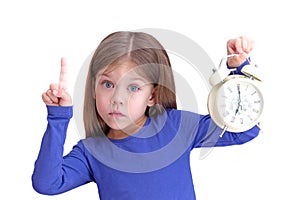 Child holding alarm with 7 o'clock and forefinger up